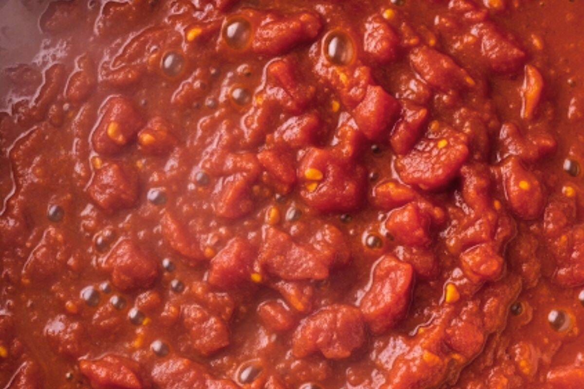 Stir in the chopped tomatoes with their juices and the tomato paste, then bring to a gentle simmer.