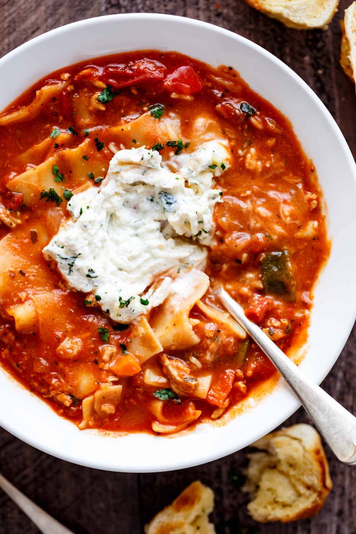 Lasagna Soup with some cream cheese on top with spoon