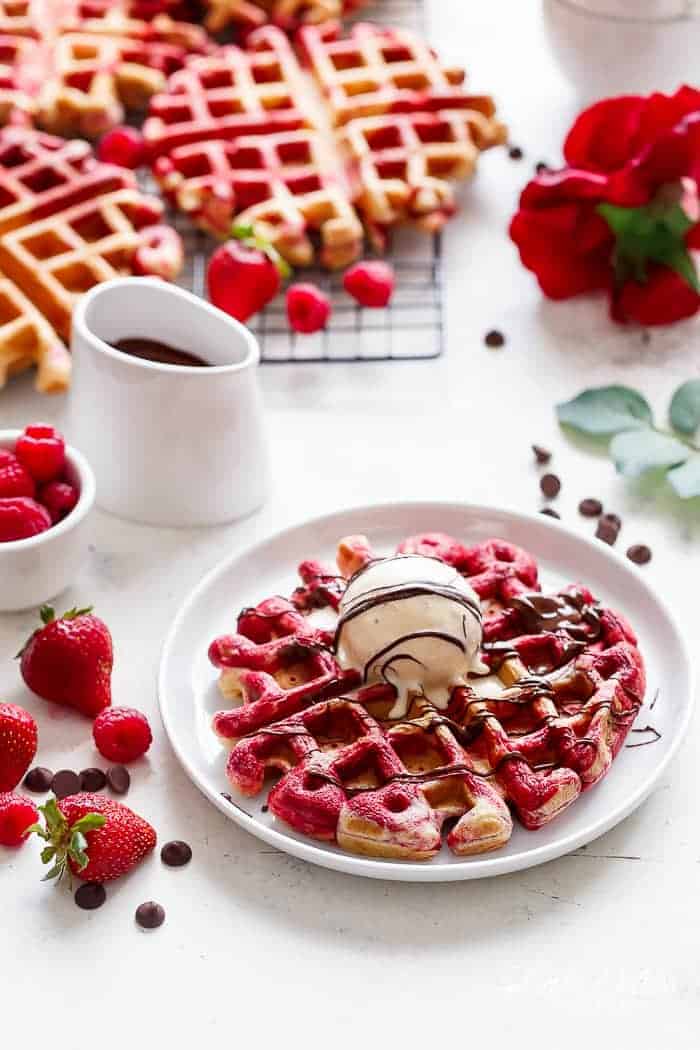 Red Velvet Marbled Waffles or Valentine's Day Waffles made healthier with Greek Yogurt are absolutely incredible! Drizzled in melted chocolate and top with ice cream for extra indulgence! | https://cafedelites.com