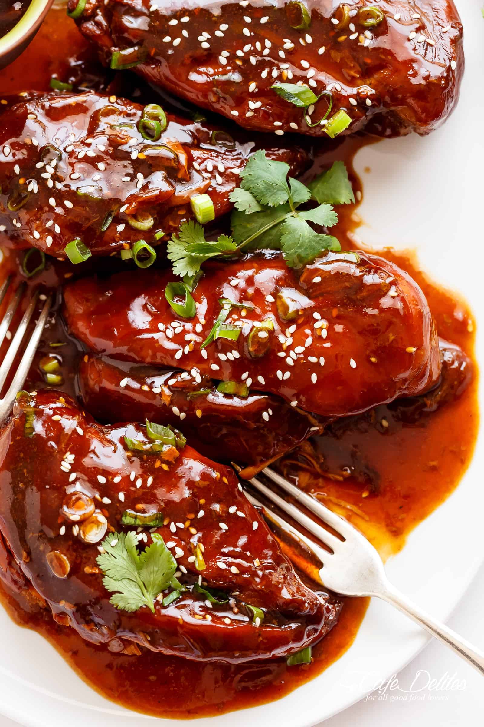 Slow Cooker Asian Glazed Chicken Breasts (or chicken thighs) for those 'throw it all in the slow cooker' days and let something else worry about your dinner! Fall apart tender chicken breast filling your house with sweet, honey garlic aromas, perfectly slow cooked and waiting for you when you get home. | cafedelites.com