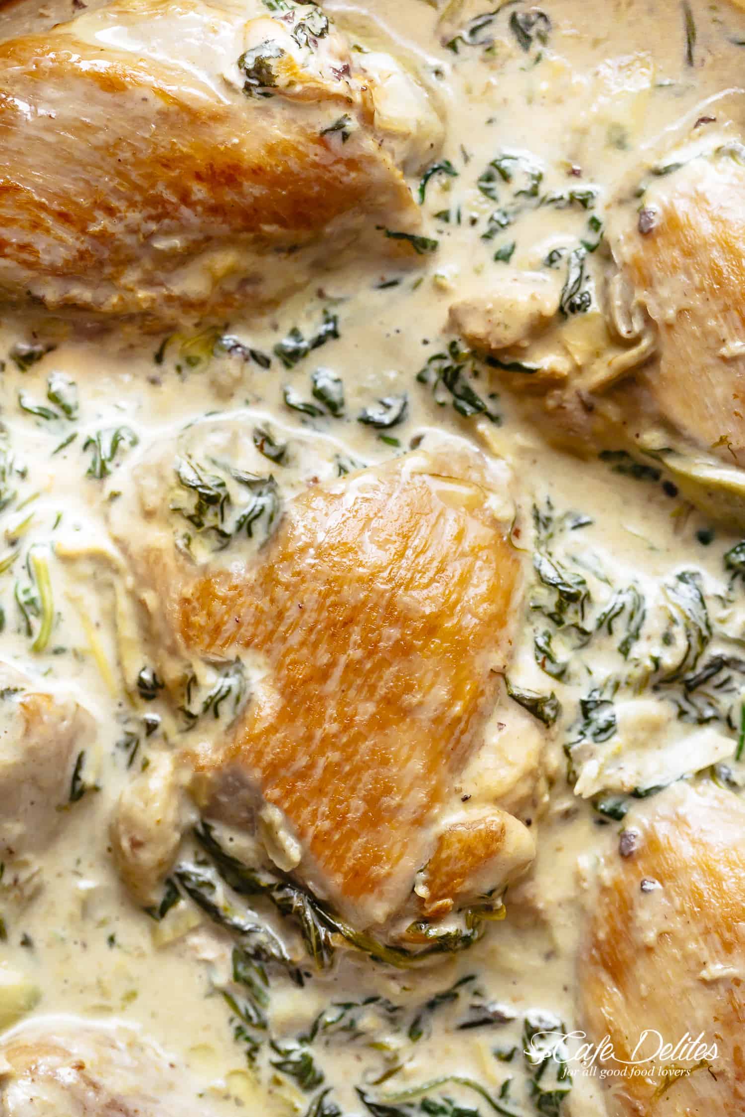 Creamy Spinach Artichoke Chicken Thighs in one skillet! Low fat AND low carb, filled with fresh spinach, artichokes, parmesan cheese and a hint of garlic! | cafedelites.com