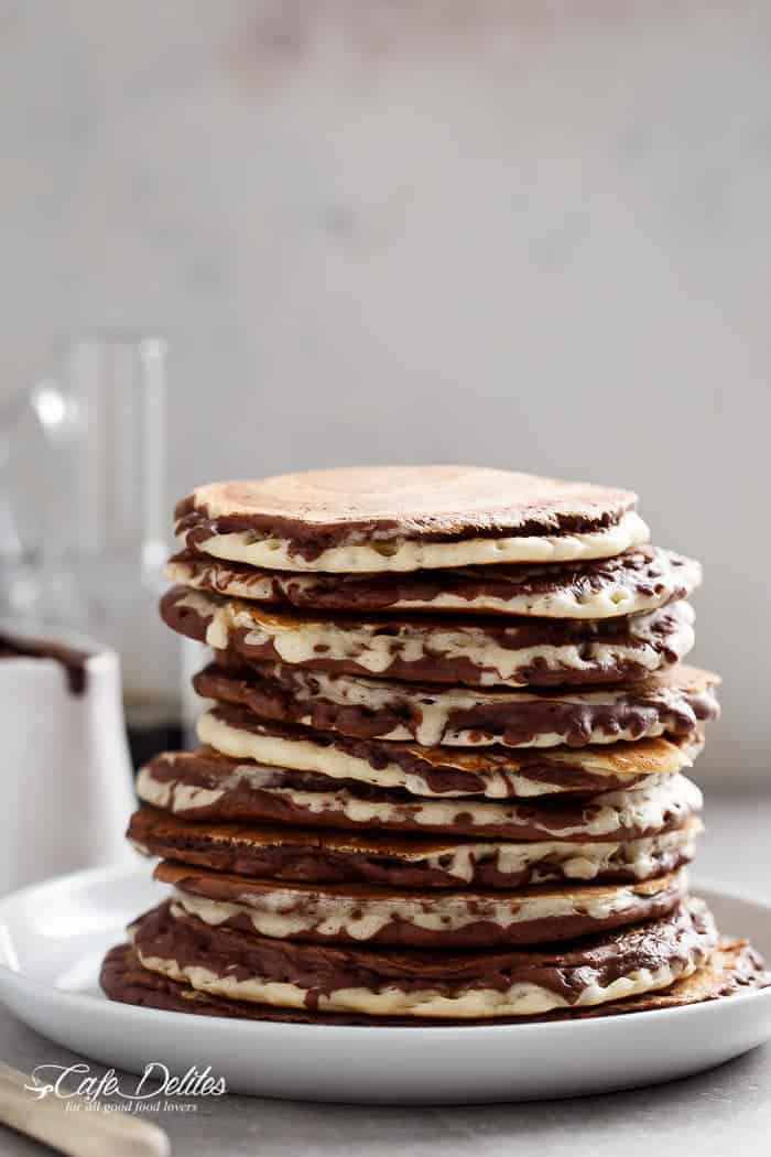 Zebra Marble Pancakes are a step up from normal pancakes and a twist on the popular Zebra cake! Incredibly easy to make AND perfectly fluffy! | https://cafedelites.com