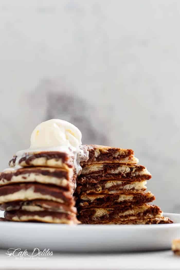 Zebra Marble Pancakes are a step up from normal pancakes and a twist on the popular Zebra cake! Incredibly easy to make AND perfectly fluffy! | https://cafedelites.com