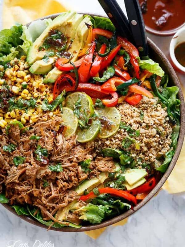 Crispy Carnitas in a salad drizzled with an incredible Chipotle Lime Dressing and a low carb Cilantro Lime Rice! in a pan