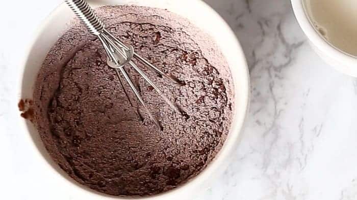 Low Fat Double Chocolate Mug Cake recipe WITH another video. Ready in less than one minute! Fluffy. Buttery and soft. The BEST low fat, guilt-free mug cake! | https://cafedelites.com