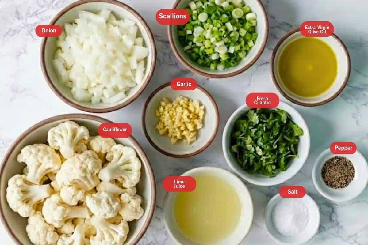 Flat lay photo of onion, scallions, extra virgin olive oil, fresh cilantro, pepper, salt, garlic, lime juice, cauliflower - 2