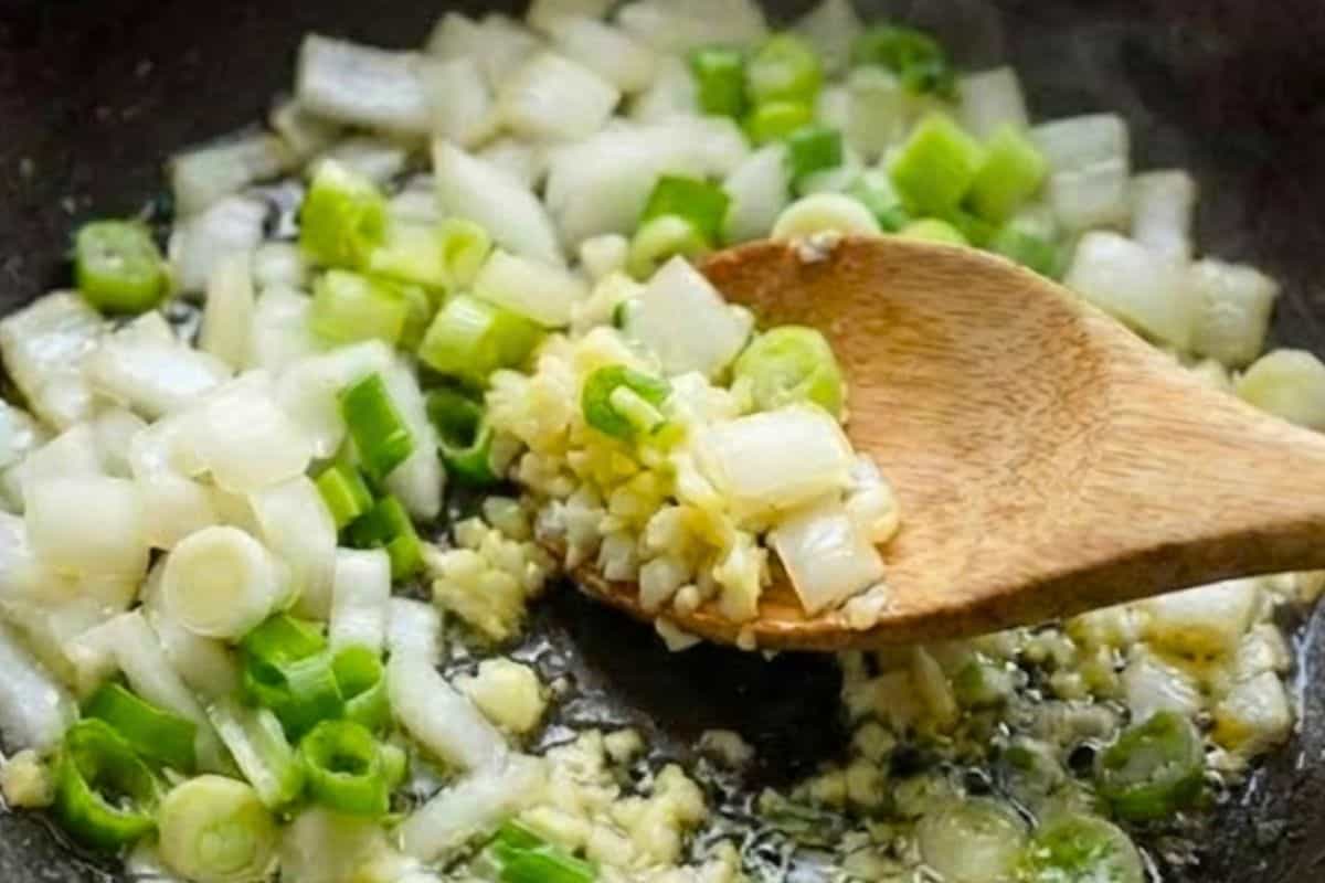 Add the onion, scallions, and garlic to the pan and sauté for about 3 minutes. - 5