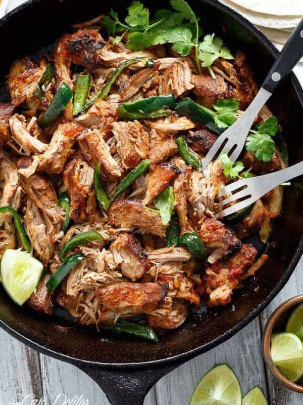 Fork pierced in Crispy Slow Cooker Carnitas in a pan