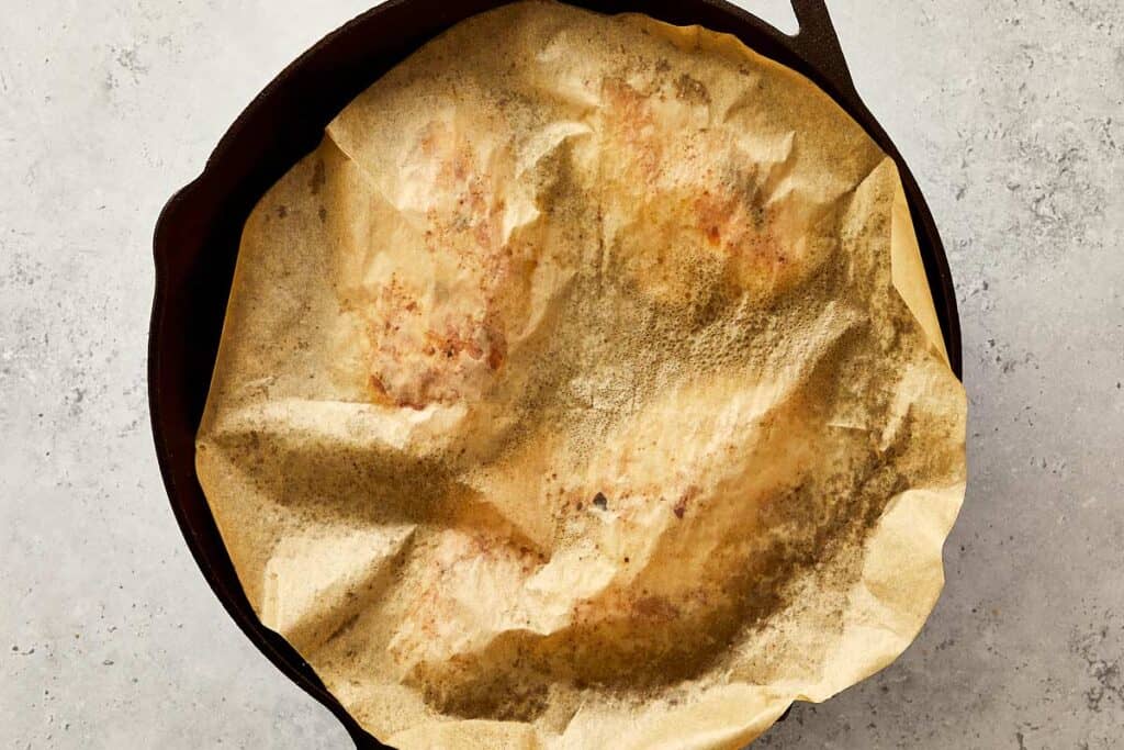 cooking sauce and chicken breasts simmering in a brown sauce