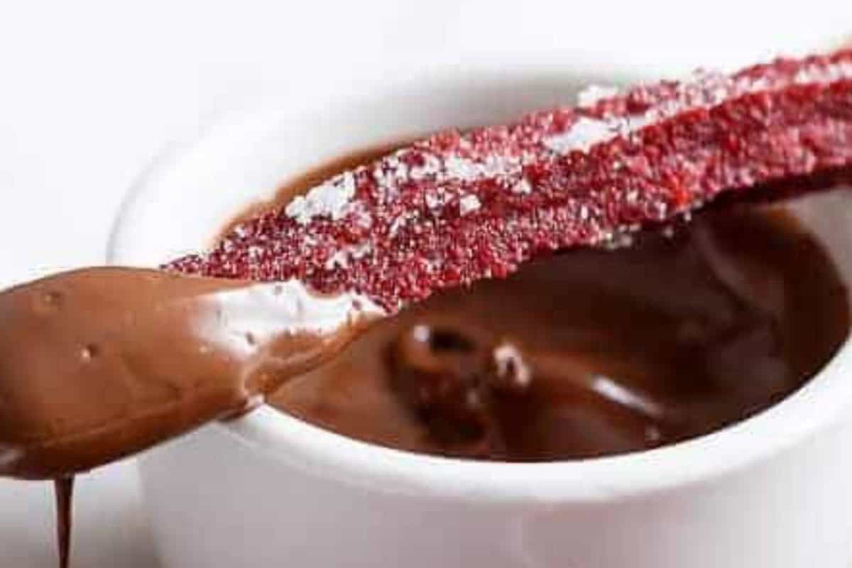 Roll the warm churros in caster sugar right out of the oven. Serve immediately with Nutella or chocolate sauce.