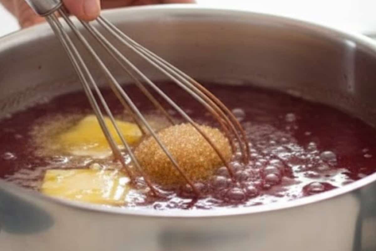In a saucepan, melt the butter and oil together. Add water, brown sugar, red food coloring, and salt.