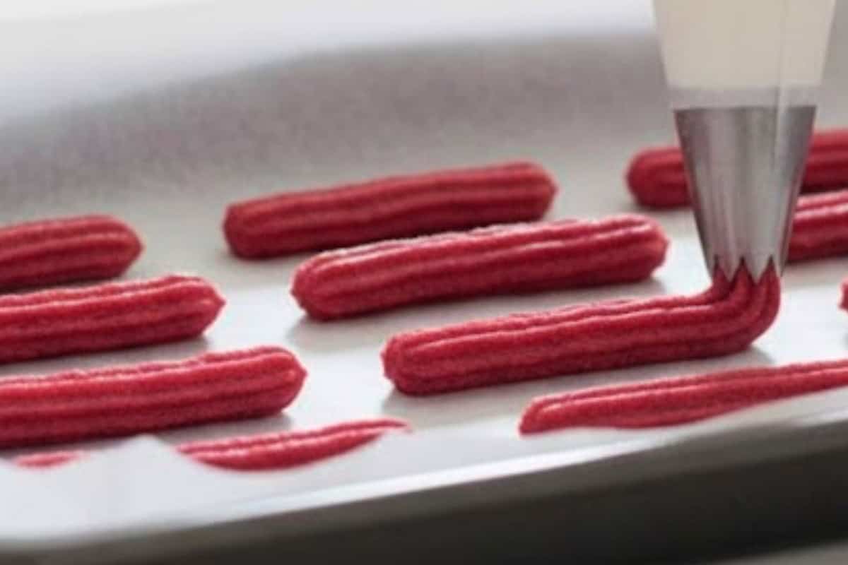 Pipe 4-inch strips onto the baking sheet, leaving space between each for expansion.