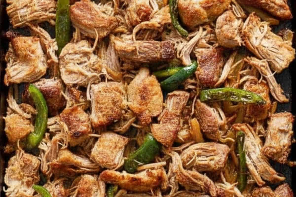 Transferred the shredded pork to a baking tray and drizzle with a bit of cooking liquid. Added the ancho chiles.