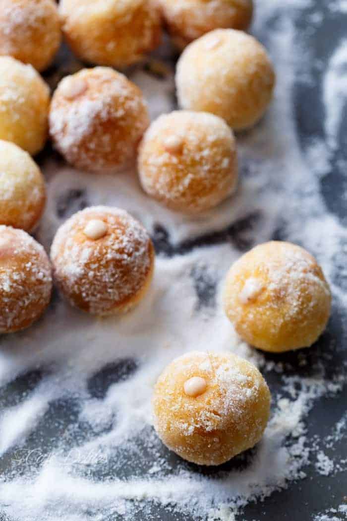 Strawberry Cheesecake Donut Holes coated with powdered sugar