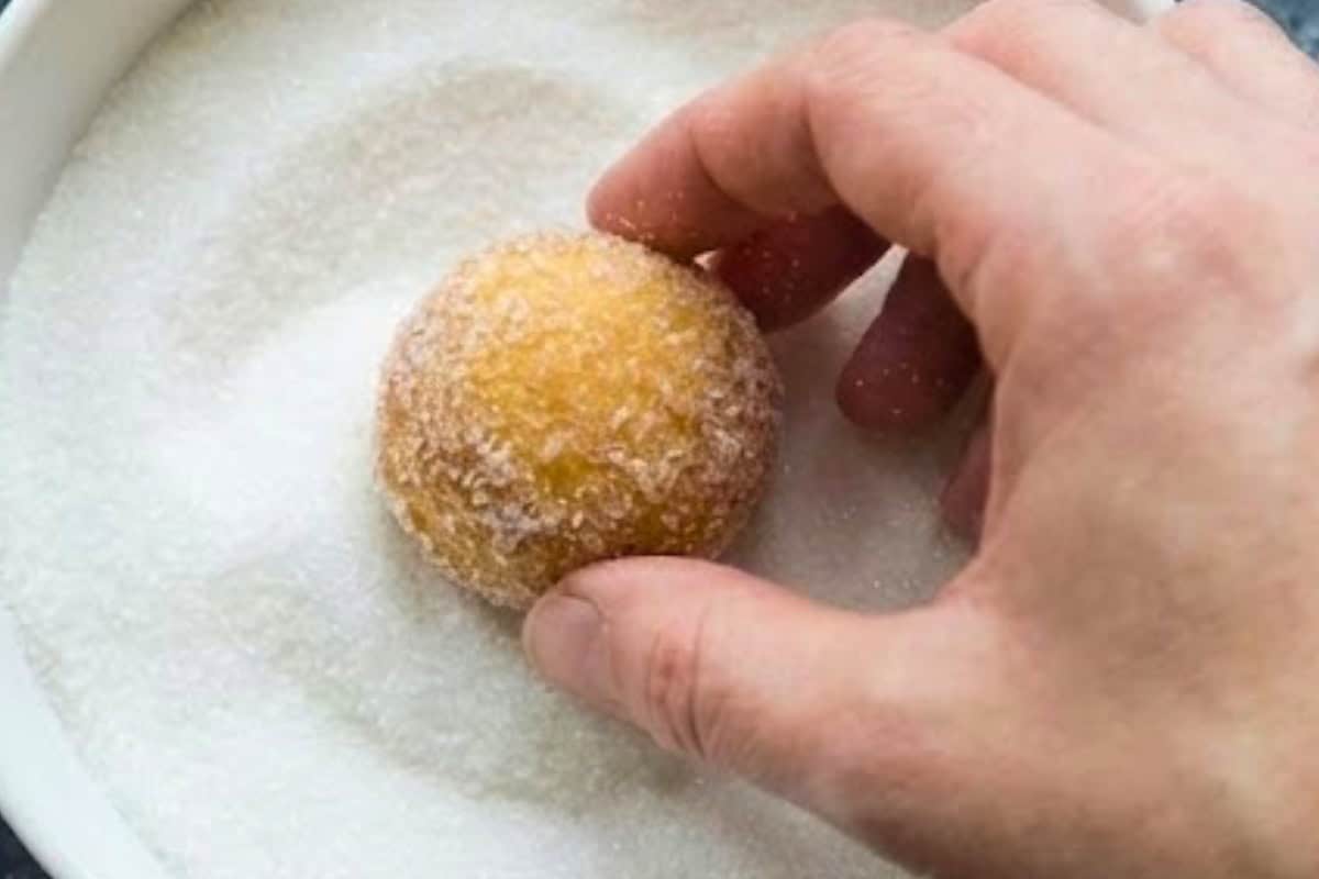 Allow the donut holes to cool for 5 minutes, then while still warm, gently roll each one in sugar until evenly coated - 8