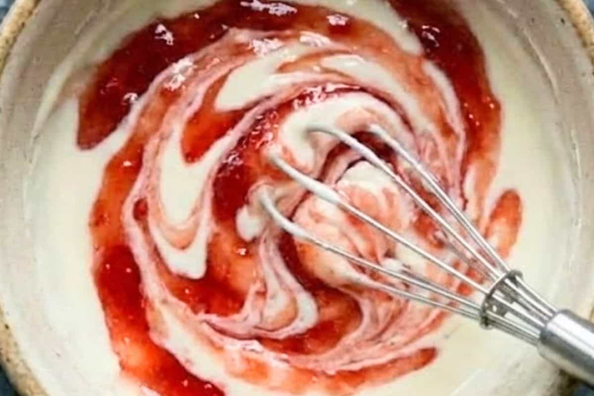  In a small bowl, beat the cream cheese and powdered sugar until smooth, then gently swirl in the strawberry jam to create a marbled effect without fully mixing. - 9