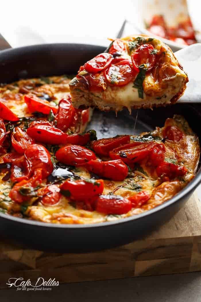 Garlic infused, Caprese Frittata with pan fried, juicy tomato and fresh basil flavors. Breakfast, brunch, lunch or dinner! Easy to make and low carb/cal! | https://cafedelites.com