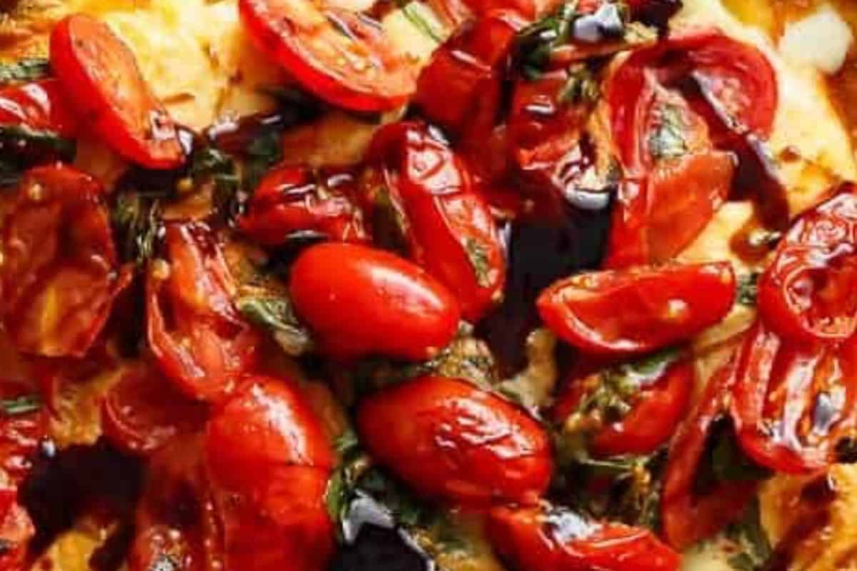 Sprinkle extra mozzarella if desired and broil until puffed, golden, and set, then spoon over the reserved tomatoes and drizzle with balsamic glaze