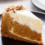 Carrot Cake Cheesecake to add to your Easter menu planning! A fluffy and super moist, lower in fat, lighter in calories carrot cake layered with a creamy, lemon scented cheesecake. The BEST of both worlds! | https://cafedelites.com