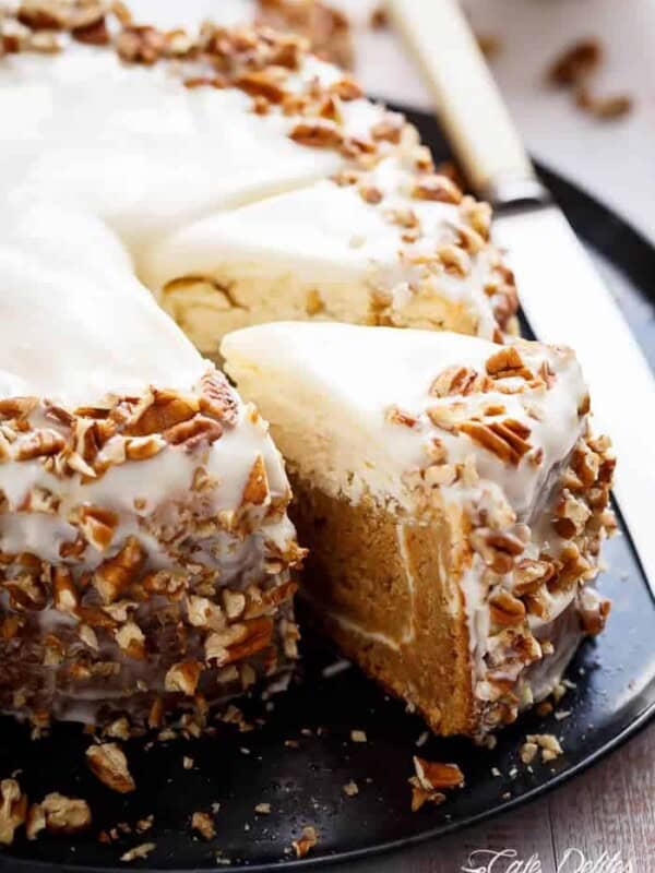 A piece of Carrot Cheesecake being taken out from the whole cheesecake