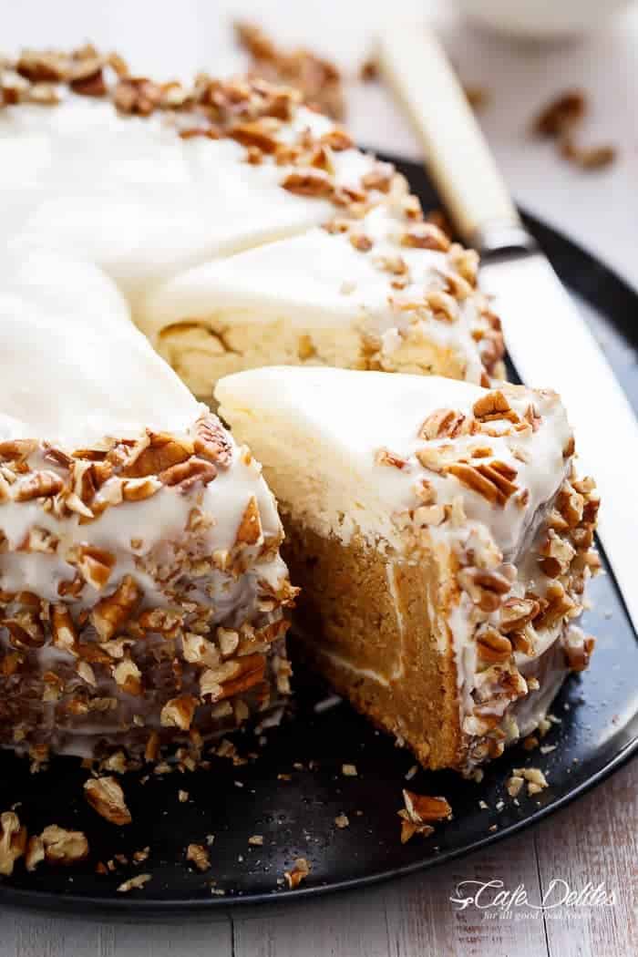 Carrot Cake Cheesecake to add to your Easter menu planning! A fluffy and super moist, lower in fat, lighter in calories carrot cake layered with a creamy, lemon scented cheesecake. The BEST of both worlds! | https://cafedelites.com