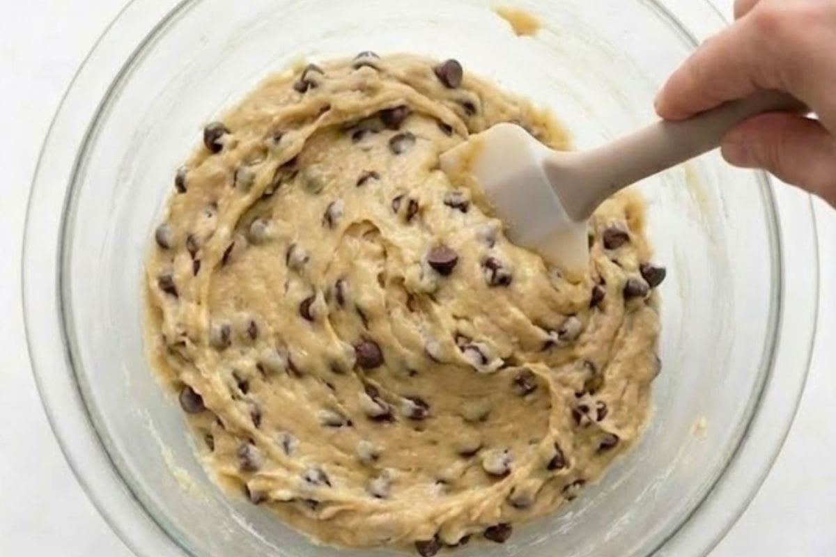 In a bowl, whisk the butter, sweeteners, and vanilla until creamy. Add flour and salt, mixing until combined, then stir in the milk gradually until the dough is smooth, soft, and creamy. Fold through the chocolate chips.