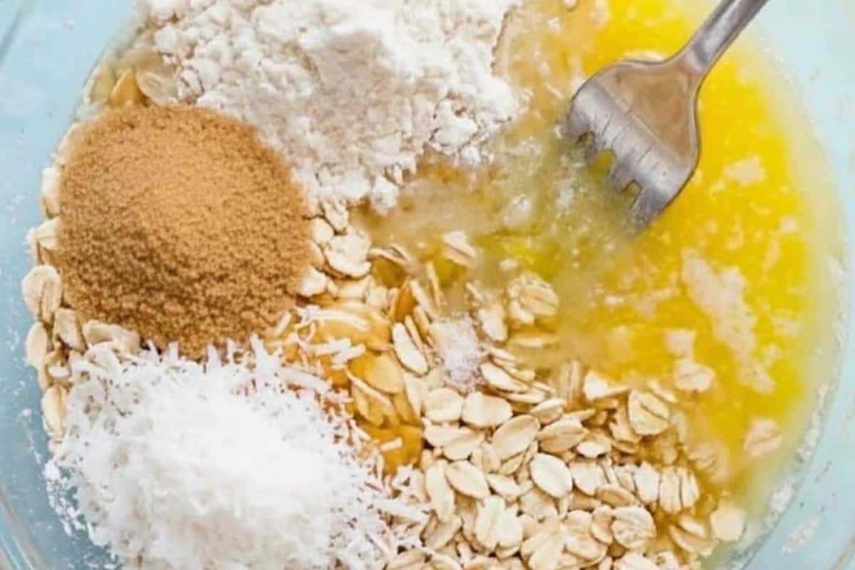 Combine oats, flour or almond meal, shredded coconut if using, honey, melted butter, sugar and salt in a medium bowl.