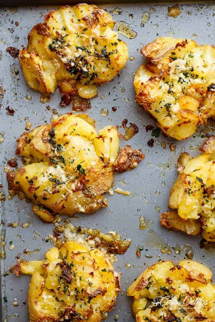 Crispy Garlic Butter Parmesan Smashed Potatoes are fluffy on the inside and crispy on the outside, smothered in garlic butter and parmesan cheese! | https://cafedelites.com