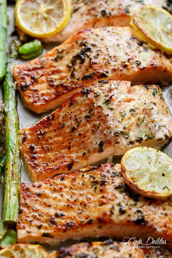Lemon, garlic and parsley are infused in One Pan Lemon Garlic Baked Salmon + Asparagus ready in only 10 minutes without any marinading! | https://cafedelites.com
