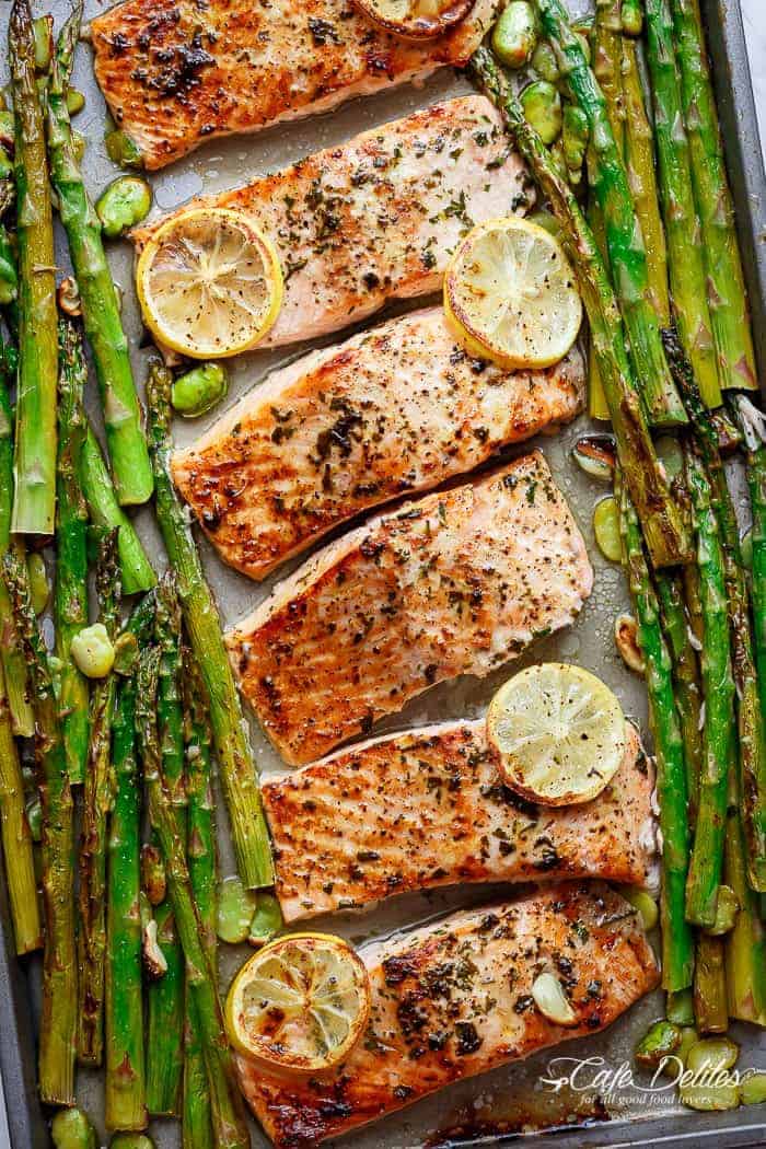 Lemon, garlic and parsley are infused in One Pan Lemon Garlic Baked Salmon + Asparagus ready in only 10 minutes without any marinading! | https://cafedelites.com