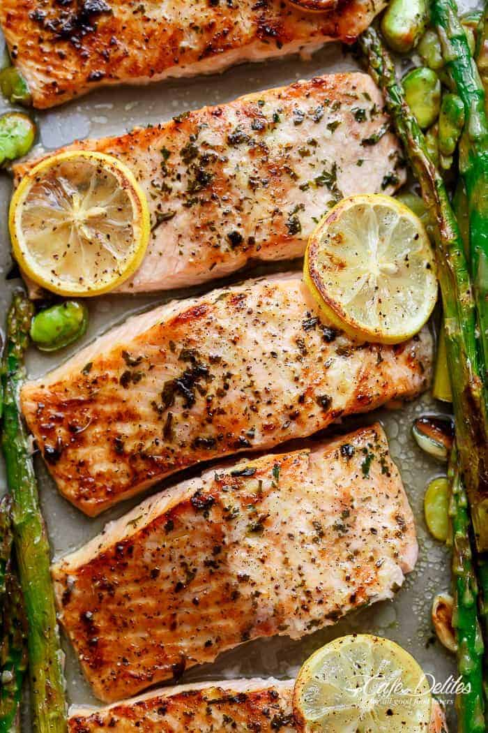 Lemon, garlic and parsley are infused in One Pan Pan Lemon Garlic Baked Salmon + Asparagus ready in only 10 minutes without any marinading! | 