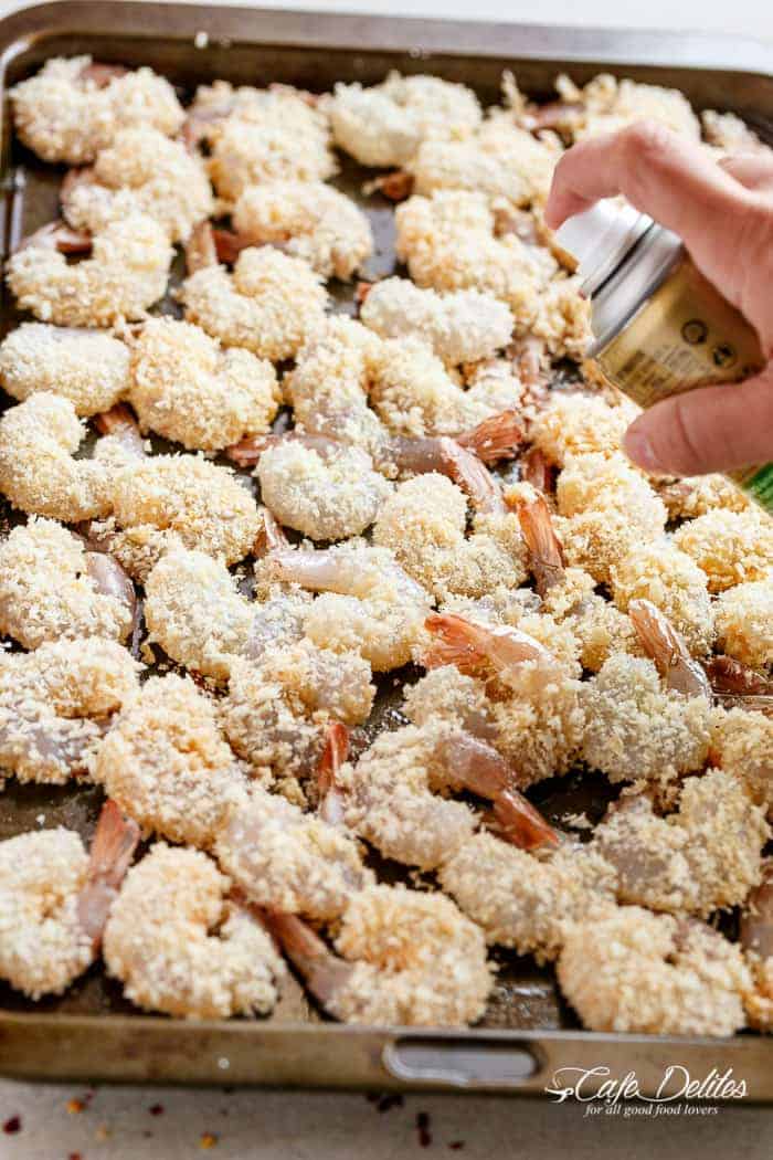 Crispy Oven Fried Crumbed Shrimp! Fresh shrimp dipped in a lightened up batter, coated in Panko for that crispy deep-fried texture without the extra fat! | https://cafedelites.com