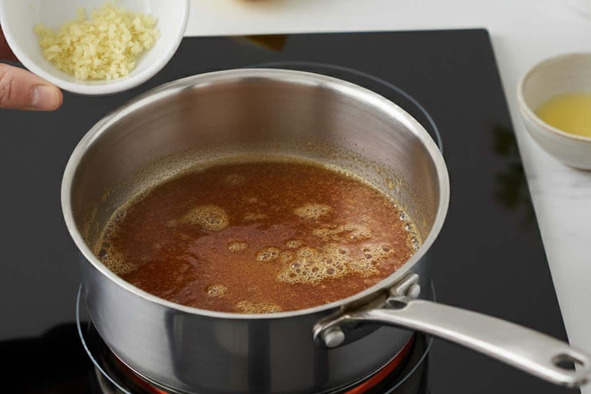 Adding the garlic to the butter.