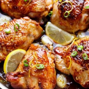 Honey Lemon Garlic Chicken pieces with lemon wedges