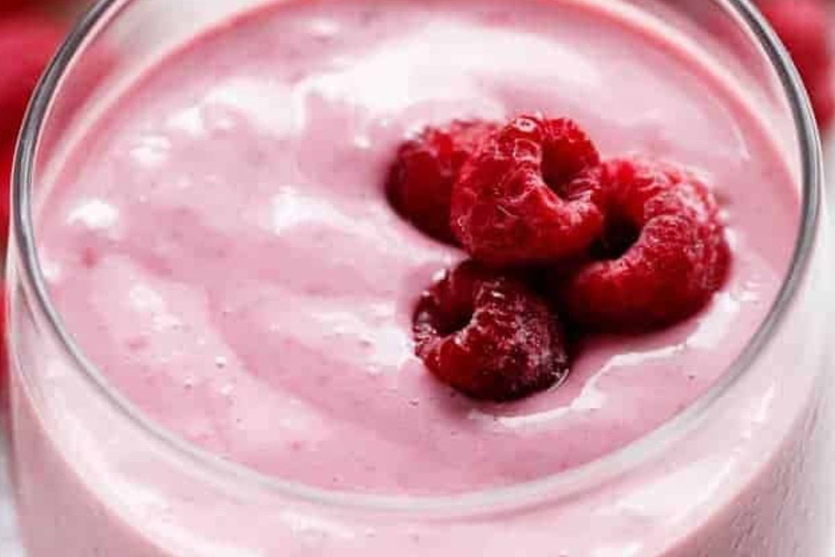 If the smoothie is too thick, pour in a little more milk and blend until it reaches your preferred consistency. Top with frozen raspberries for a refreshing finish.