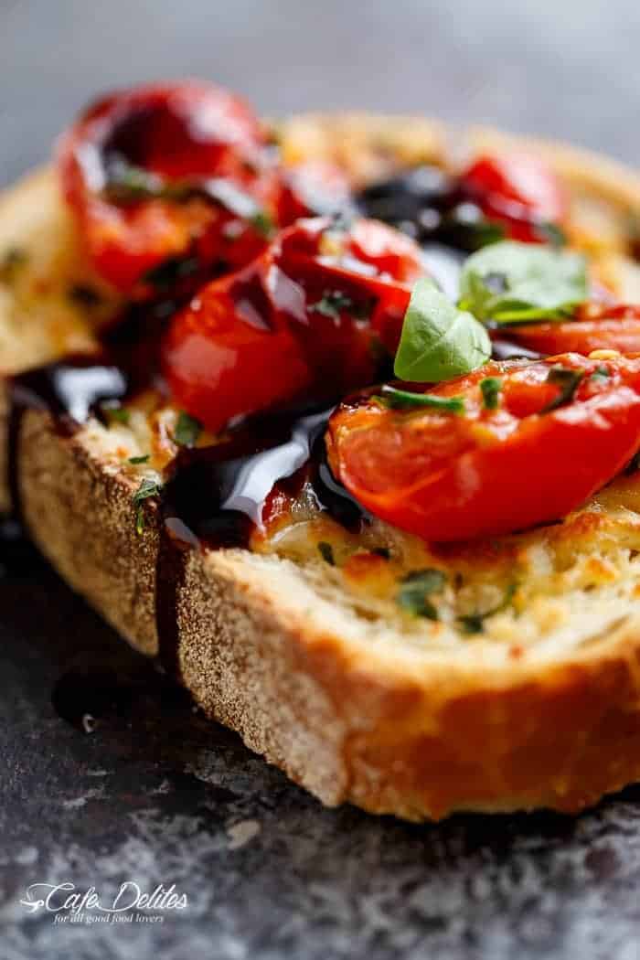 Tomato Caprese Garlic Breads with melted mozzarella cheese is taking a normal Garlic Bread and transforming it into something incredible in minutes! | https://cafedelites.com