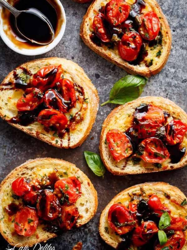 Tomato Caprese Garlic Breads with melted mozzarella cheese