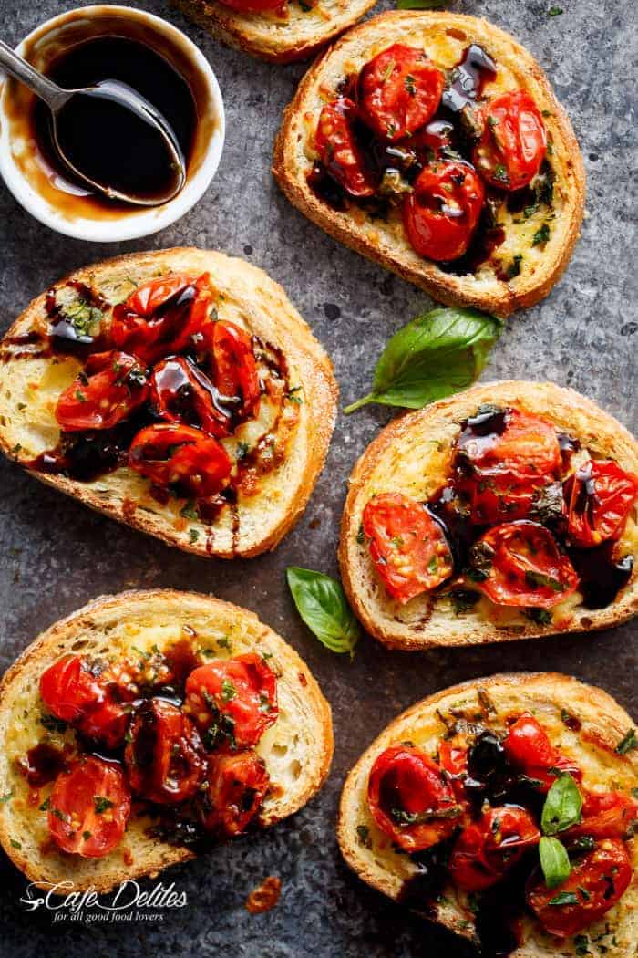Tomato Caprese Garlic Breads with melted mozzarella cheese is taking a normal Garlic Bread and transforming it into something incredible in minutes! | https://cafedelites.com