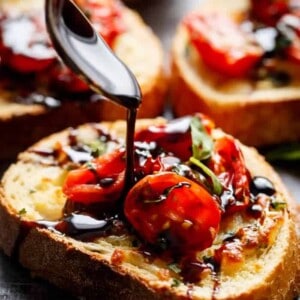 Tomato Caprese Garlic Breads with melted mozzarella cheese