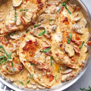 Creamy Sun Dried Tomato Parmesan Chicken on a baking tray