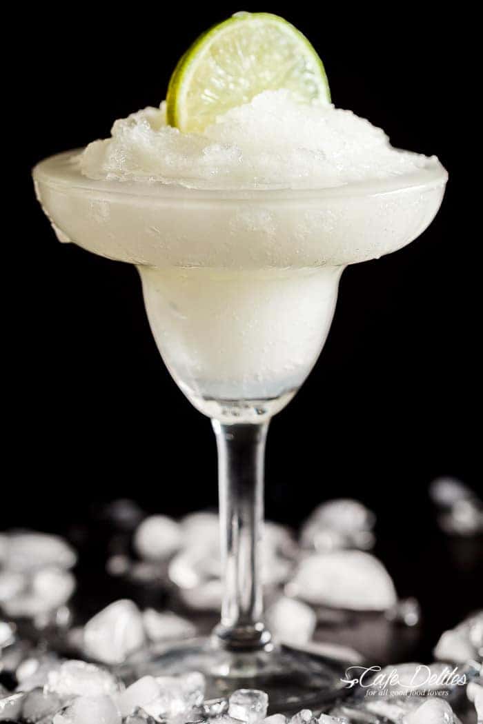 Frozen Margarita Slushy blends the original Margarita made with Tequila and fresh lime juice with ice cubes to make a refreshing icy drink! | https://cafedelites.com
