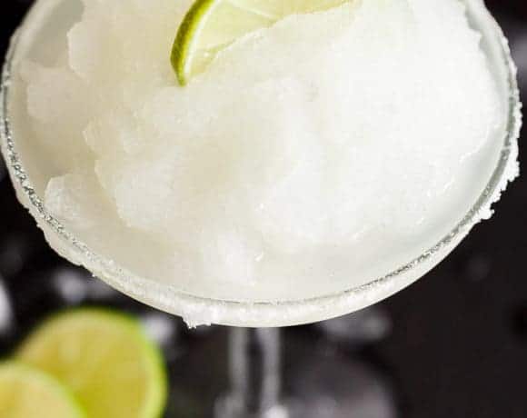 Frozen Margarita Slushy blends the original Margarita made with Tequila and fresh lime juice with ice cubes to make a refreshing icy drink! | https://cafedelites.com