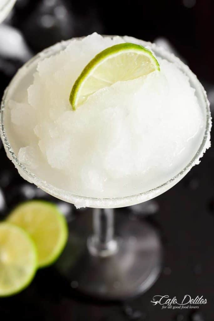 Frozen Margarita Slushy blends the original Margarita made with Tequila and fresh lime juice with ice cubes to make a refreshing icy drink! | https://cafedelites.com