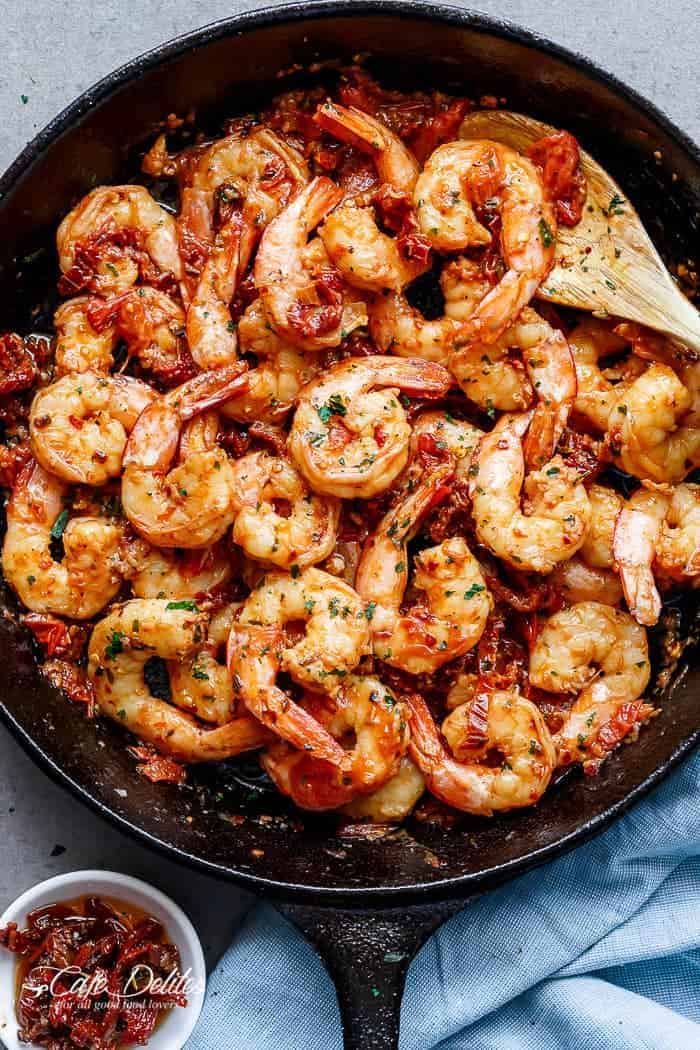 Spicy and garlicky with the subtle sweetness of sun dried tomatoes, this Spicy Garlic Sun Dried Tomato Shrimp takes less than 10 minutes! | https://cafedelites.com