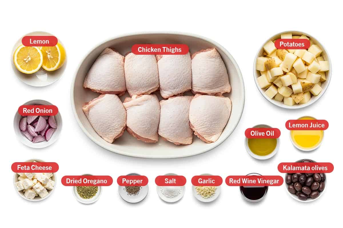 Top shot of ingredients: Lemon, red onion, feta cheese, chicken thighs, potatoes, olive oil, lemon juice, dried oregano, pepper, salt, garlic, red wine vinegar, and kalamata olives.