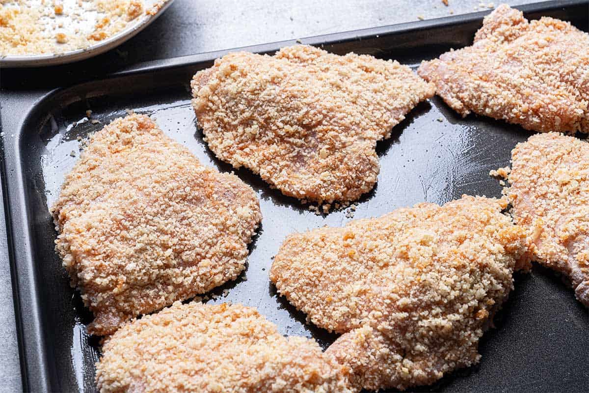 crumbed and coated chicken sitting on a baking tray