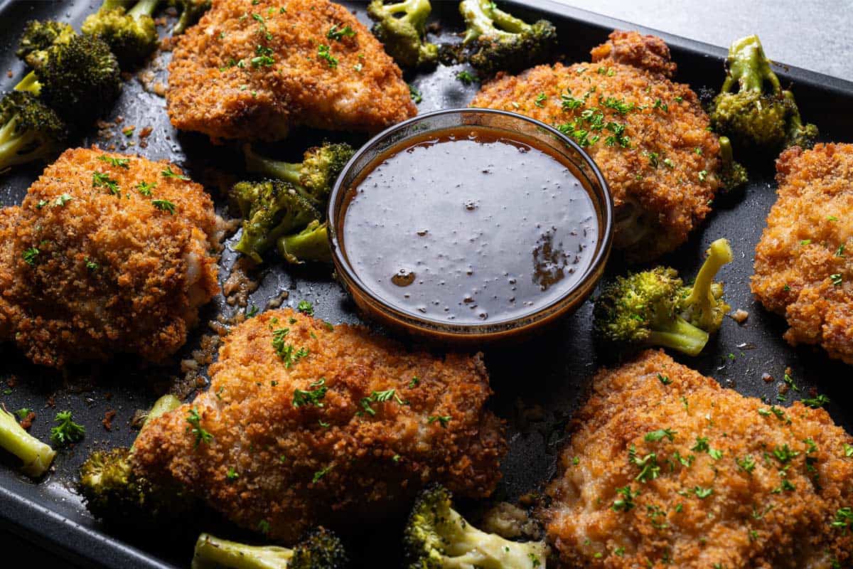 Oven Fried Chicken with broccoli and honey garlic dipping sauce  cooked on a tray