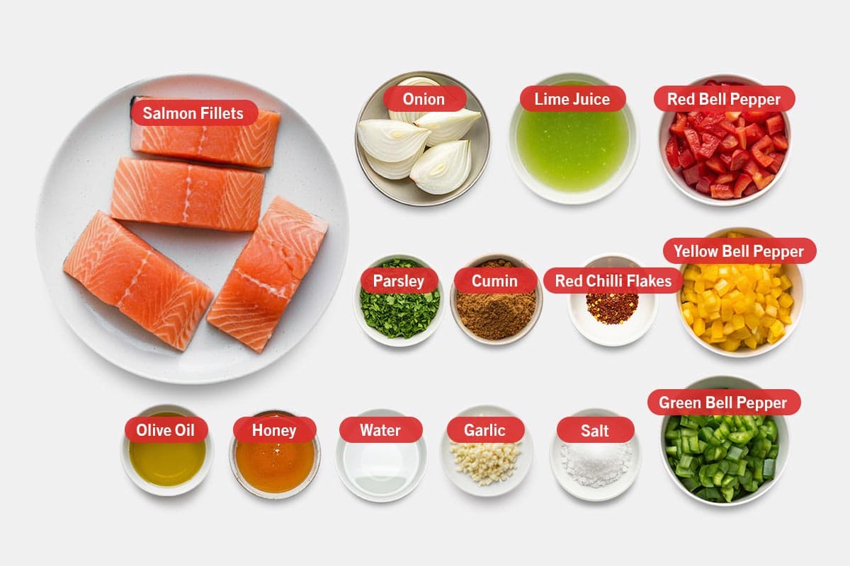 Top shot of ingredients: Salmon fillets, onion, lime juice, red bell pepper, yellow bell pepper, green bell pepper, parsley, cumin, red chilli flakes, olive oil, honey, water, garlic, and salt.