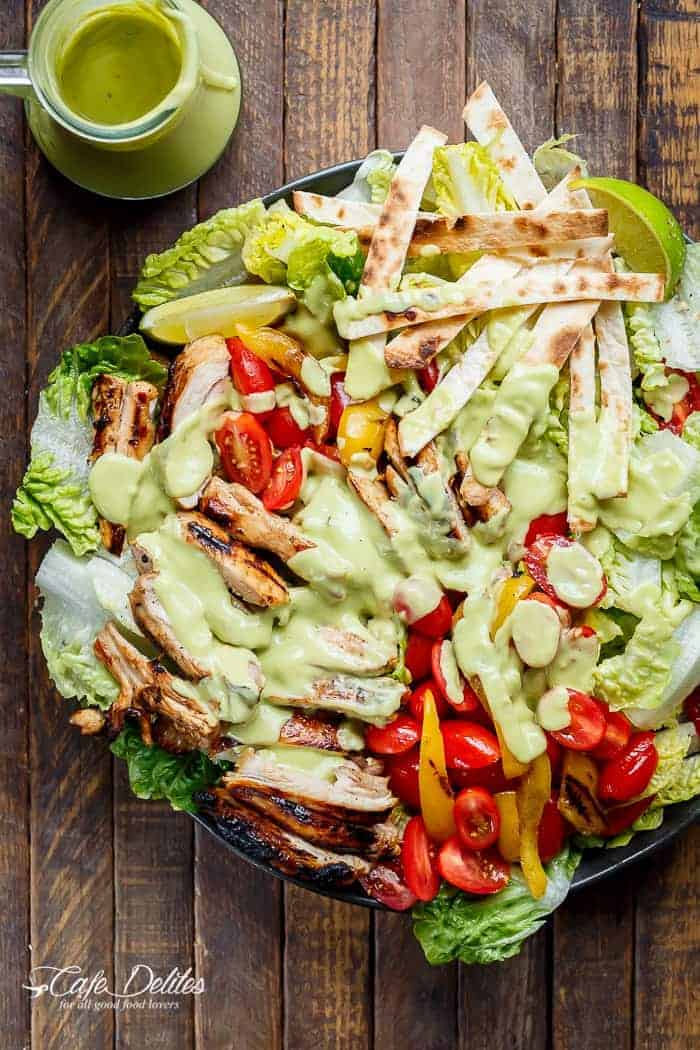 Tequila Lime Chicken Taco Salad with an Avocado Crema spiked with honey, lime and booze. Complete with tortilla strips, have a chicken taco in a salad! | https://cafedelites.com