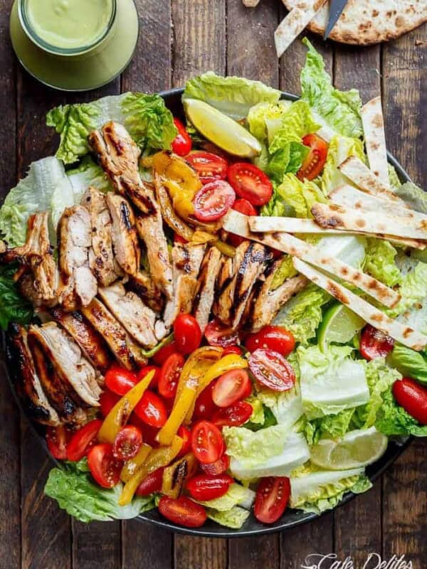 Tequila Lime Chicken Taco Salad with an Avocado Crema spiked with honey, lime and booze. Complete with tortilla strips, have a chicken taco in a salad!